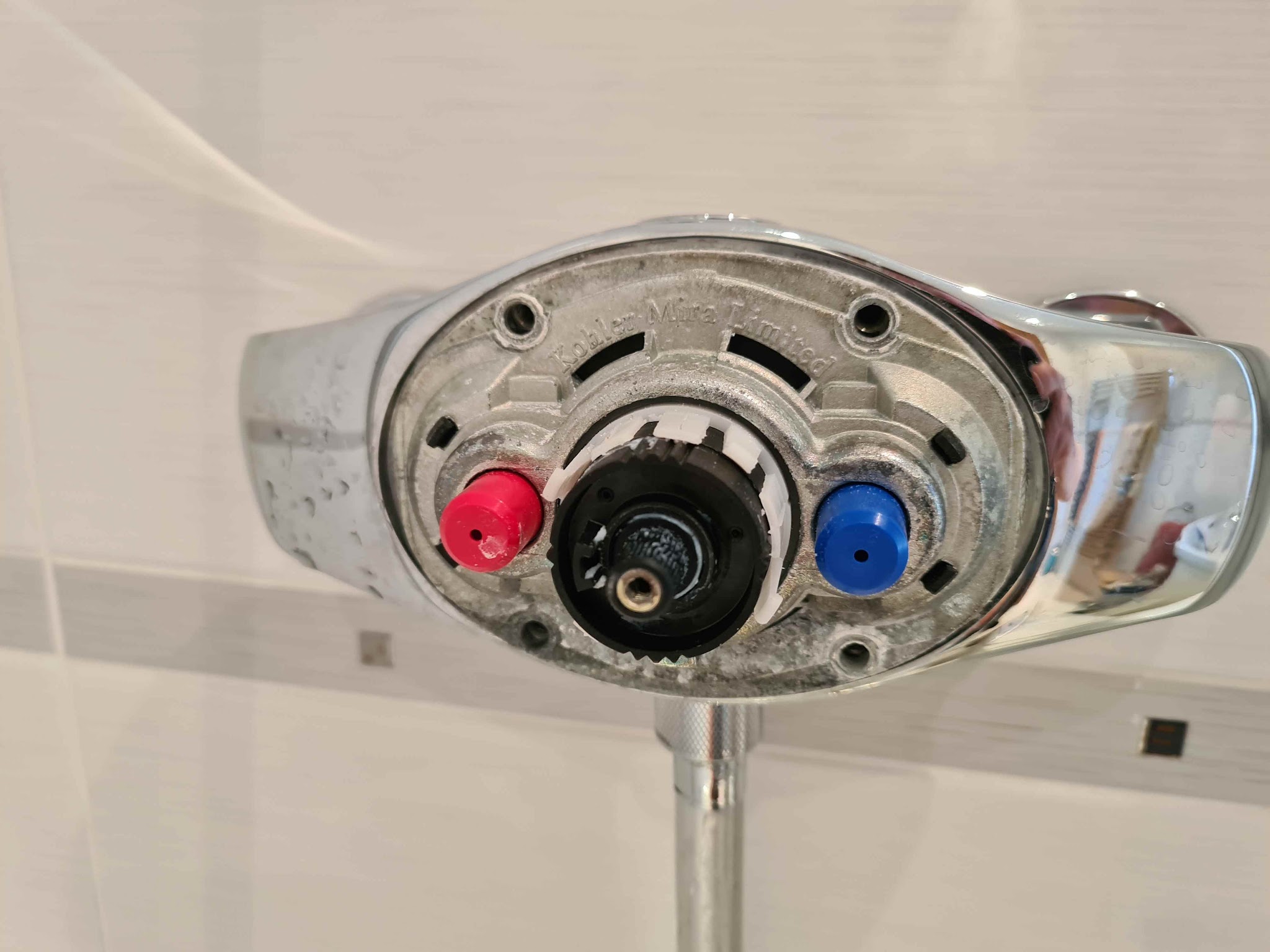 A thermostatic shower valve with its cover off, part way through a repair